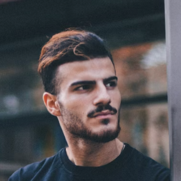 Man in black cap looking away